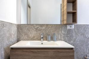 a bathroom with a sink and a mirror at New and Vintage Villa - Anni 70' in Alghero +20 photos