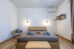 a bedroom with a bed and a chair at New and Vintage Villa - Anni 70' in Alghero