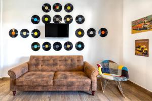 a living room with a couch and a wall of records at New and Vintage Villa - Anni 70' in Alghero