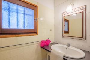 a bathroom with a sink and a mirror at Gîte Des Louveteaux in Banne +14 photos