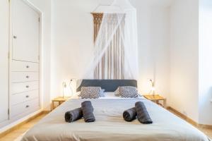 a bedroom with a bed with two pillows on it at Casa Llimoner con piscina in Sant Llorenç des Cardassar +33 photos