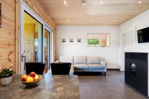a living room with a table and a couch at Mettmapark - Chalet 1 in Grafenhausen
