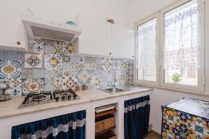 a kitchen with a sink and a stove at Casa Del Pescatore in Trappeto +16 photos