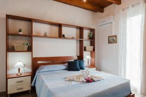 a bedroom with a bed with a blue comforter at Casa Del Pescatore in Trappeto