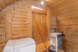 a log cabin bathroom with a washer and dryer at Pod Anis in Saint-André