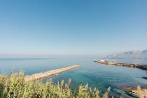 a large body of water with a dock in it at Casa Del Pescatore in Trappeto