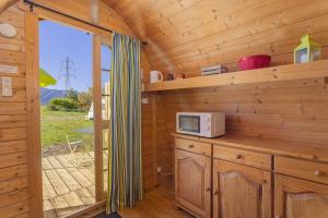a kitchen with a microwave on a counter in a cabin at Pod Anis in Saint-André