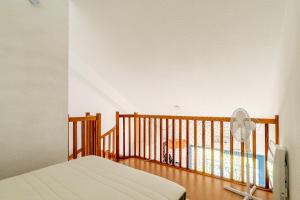 a bedroom with a bed and a balcony with a fan at La Cabine du Marin - 73 in Pornic