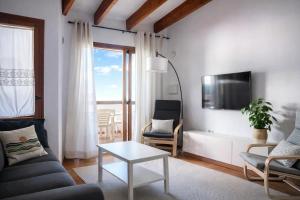 a living room with a couch and a table at Costa Arenal - Biniplaya in Arenal d'en Castell