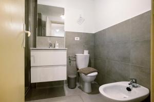 a bathroom with a toilet and a sink at Casa Brando in Corralejo +25 photos