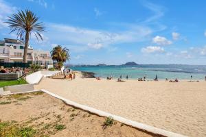 a group of people on a beach near the ocean at Casa Brando in Corralejo