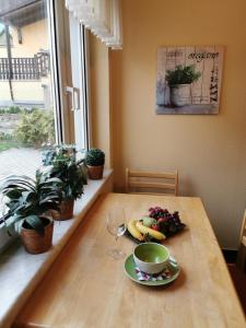 a table with a bowl of fruit and a cup of coffee at Ferienhaus Enger in Saalfeld +10 photos