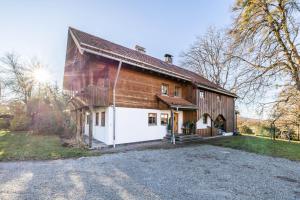 a large wooden barn with a white garage at Haus am Bach in Benediktbeuern