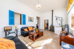 a living room with a couch and a table at Cas Padri Teco in Ariany