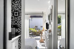 a bedroom with a bed and a dining room with a table at Chambre D'hôtes Toi Et Moi - in Pornic