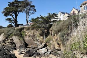 a house on the side of a rocky cliff at Chambre D'hôtes Toi Et Moi - in Pornic