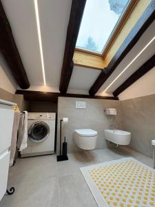 a bathroom with a sink and a washing machine at Chalet Marianna in Meltina +20 photos