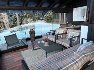 a living room with couches and a view of a pool at Chalet Marianna in Meltina