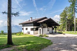a white house with a black roof at Chalet Marianna in Meltina