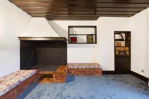 a room with a fireplace with two beds in it at Sonho No Mondego in Penacova +37 photos