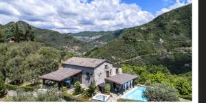 an aerial view of a house with a swimming pool at Villa Daphne Pool And Jacuzzi in Vescina