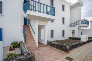 an exterior view of a white building with a staircase at Casa Dragos in Costa Teguise