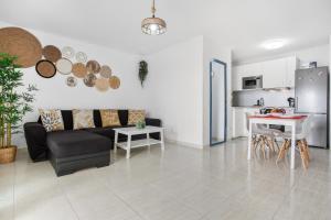 a living room with a couch and a table at Casa Dragos in Costa Teguise
