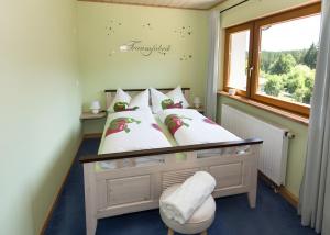 a bedroom with a bed and a window at Ferienhaus Apfelbäumchen Lenzkirch in Lenzkirch