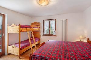 a bedroom with a bunk bed and a ladder at Ciasa Civetta in Piaia
