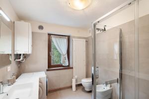 a bathroom with a shower and a toilet and a sink at Ciasa Civetta in Piaia +37 photos