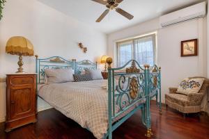 a bedroom with a bed and a ceiling fan at Villa Ottaviano By Immobilux in Arco
