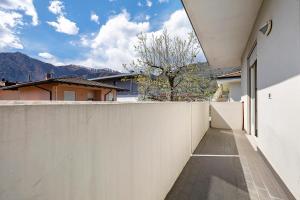 a white fence with a walkway in front of a house at Villa Ottaviano By Immobilux in Arco