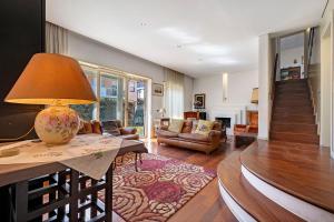 a living room with a table with a lamp on it at Villa Ottaviano By Immobilux in Arco