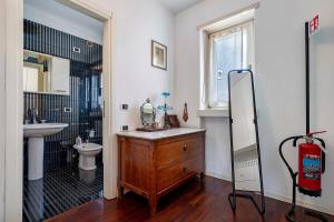 a bathroom with a wooden dresser and a sink at Villa Ottaviano By Immobilux in Arco +34 photos