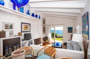 a living room with a couch and a table and chairs at Villa Bini Sek in Binibeca