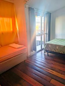 a bedroom with two beds and a window with a view at Casas Container Cassino in Rio Grande +58 photos