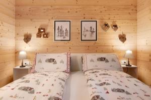 a bedroom with a bed and two pictures on the wall at A casa di Anna in Madesimo