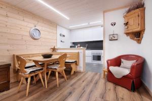 a kitchen and dining room with a table and chairs at A casa di Anna in Madesimo
