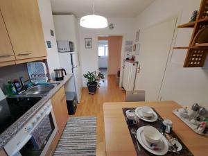 a small kitchen with a sink and a table at Algetet Apartment in Hannover