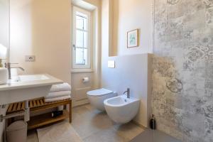 a bathroom with a toilet and a sink at Dimora Sella - Casa Monica in Alghero +50 photos