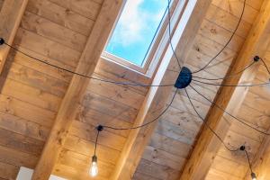 a chandelier in a room with a wooden ceiling at Ca' Vittorio in Rossiglione +174 photos