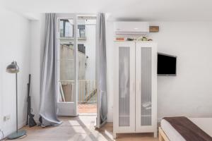 a bedroom with a bed and a sliding glass door at Portblanc Loft in Arenys de Mar