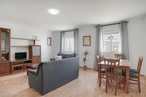 a living room with a couch and a table at Piso Ana Paula 1 in Conil de la Frontera