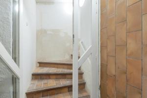 a glass door leading up to a set of stairs at Portblanc Loft in Arenys de Mar +17 photos