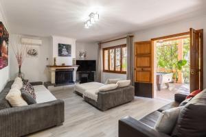 a living room with two couches and a fireplace at Finca Can Lluc in Alaró