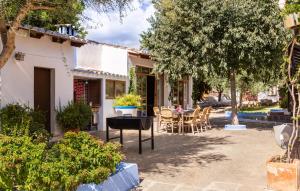 a house with a table and chairs in the yard at Finca Can Lluc in Alaró