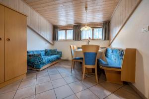 a living room with a table and a couch at App Sonne Nr 22 in Lutago