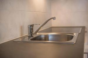 a stainless steel kitchen sink with a faucet at App Sonne Nr 22 in Lutago +11 photos