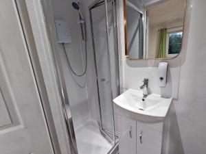 a bathroom with a sink and a shower at Azalea Studio - Self Contained One-Bed Studio Flat in Oxford