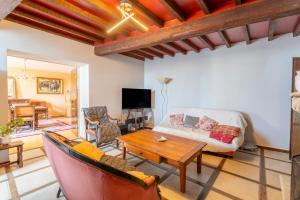 a living room with a couch and a table at Les Conils in Saint-Pierre-de-Vassols